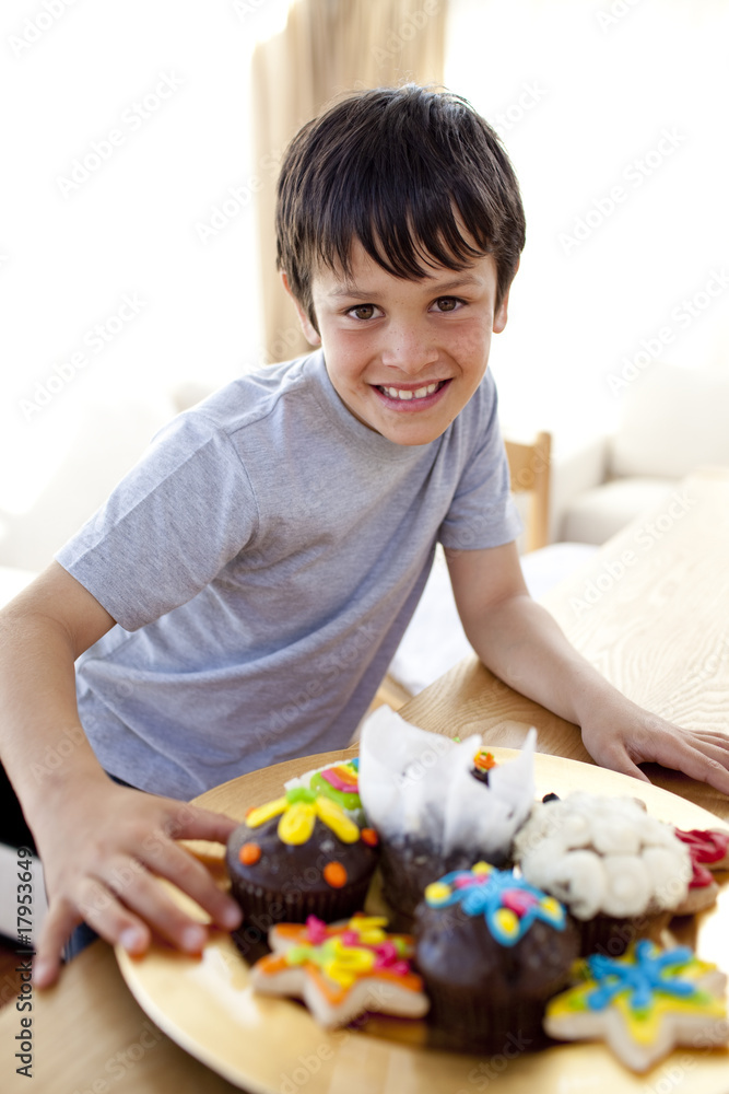 Happy boy eating colorful confectionery Happy boy eating colorful confectionery