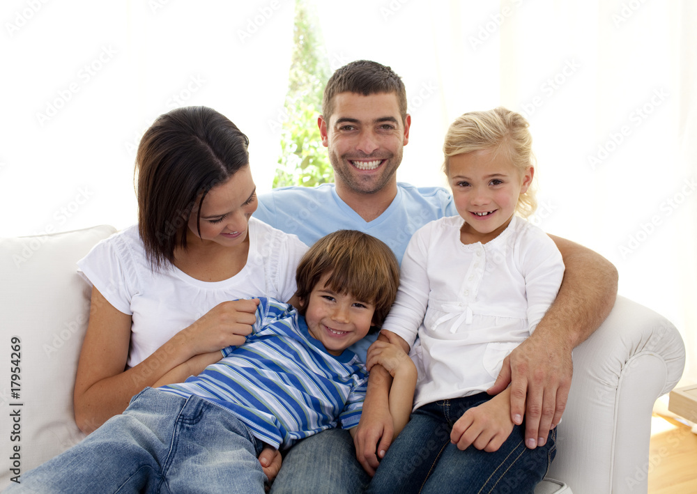 Playful family sitting on sofa at home Playful family sitting on sofa at home
