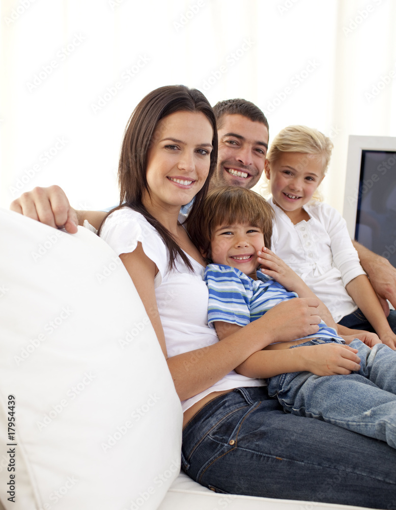 Happy parents and children sitting on sof Happy parents and children sitting on sof