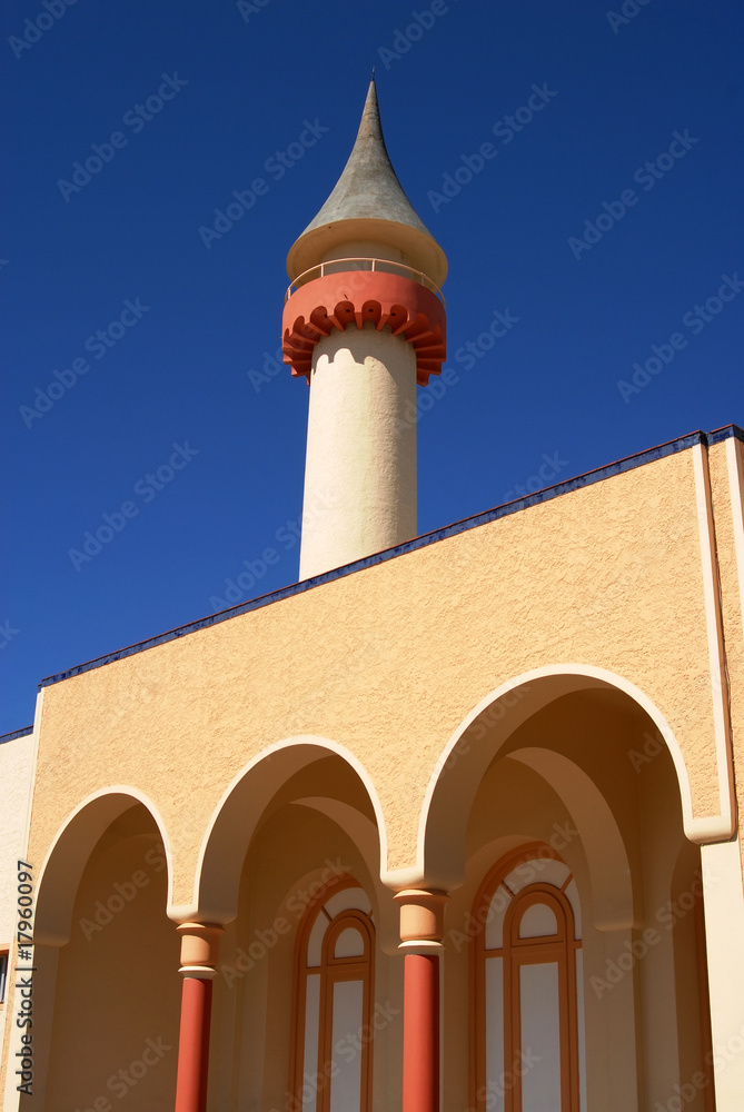 Tower and arcades detail on blue sky background