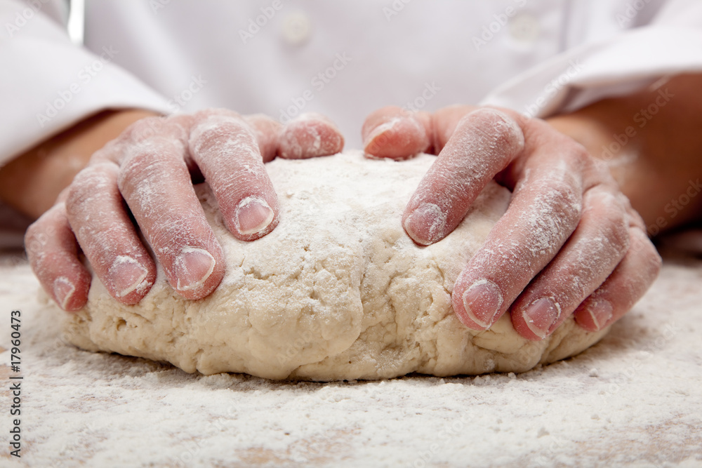 hands kneading bread dough