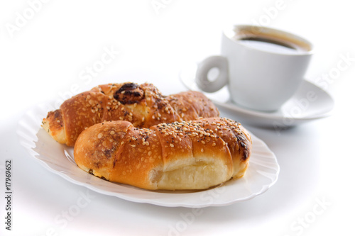 Croissants and coffee cup isolated on white