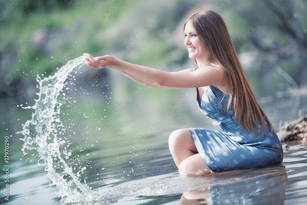 Young woman playing with water