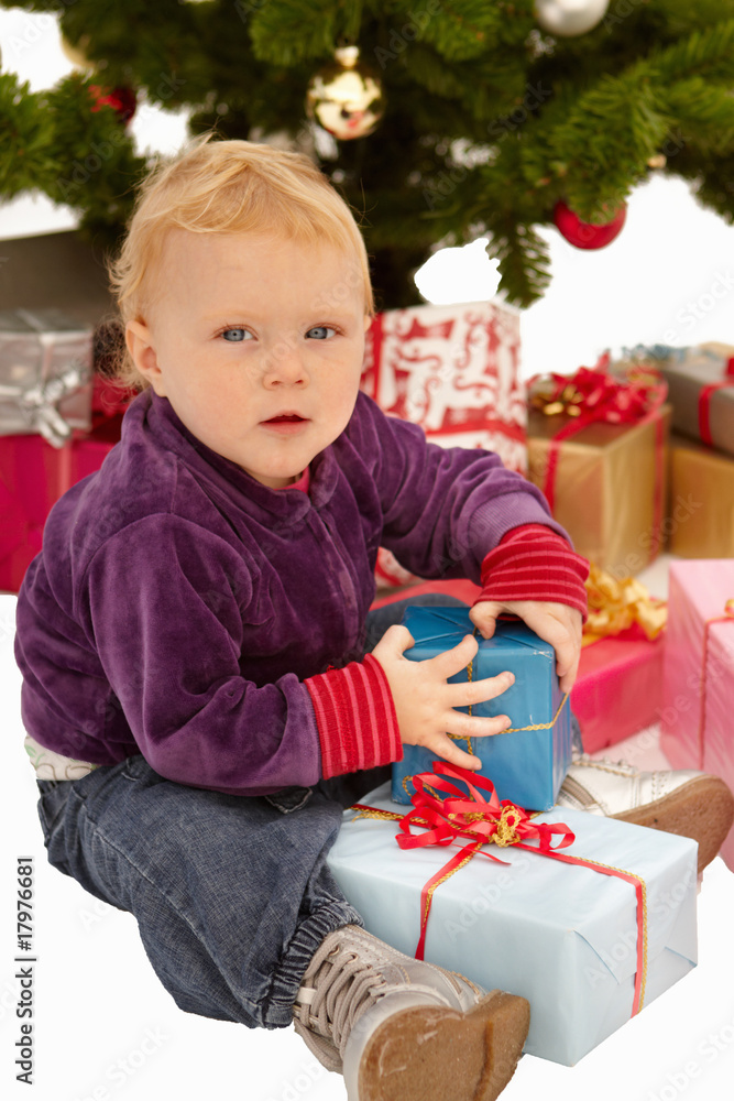 Christmas - Child caught opening gifts under tree Christmas - Child caught opening gifts under tree