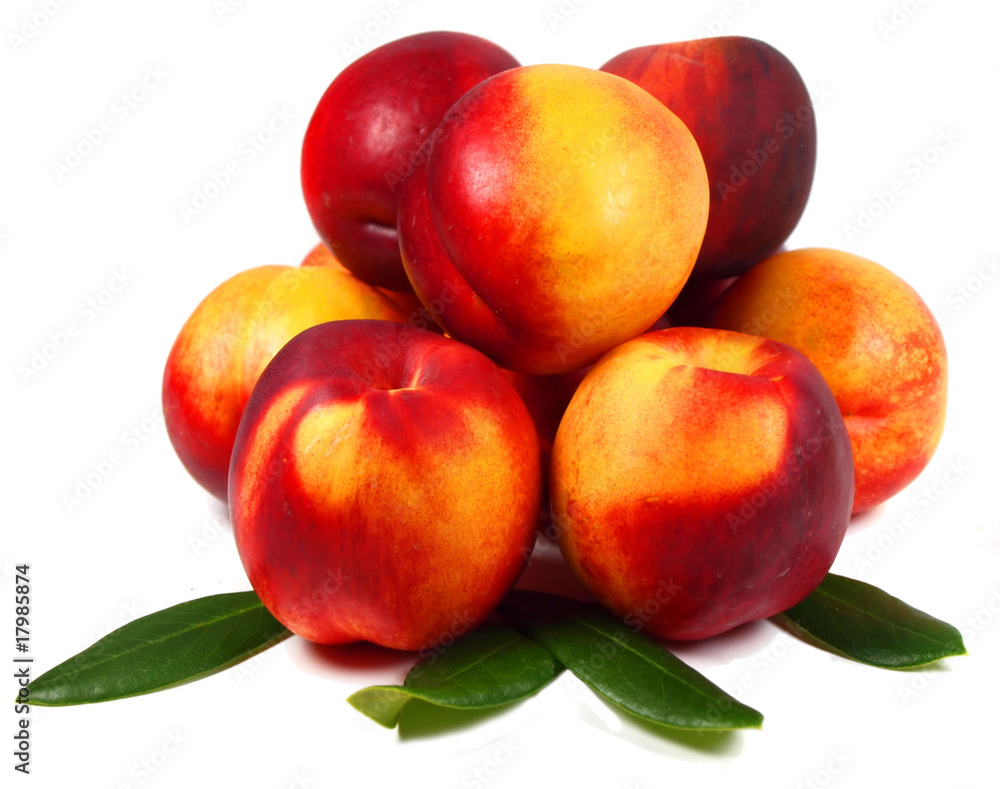 Peaches with slices and leaves isolated on white Peaches with slices and leaves isolated on white