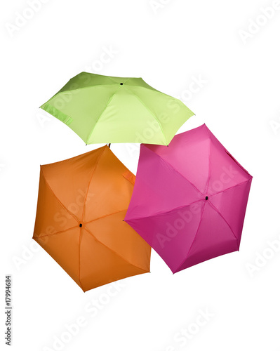 three colored umbrellas green pink orange color isolated on white background