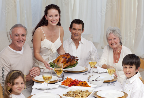Family eating turkey in a dinner