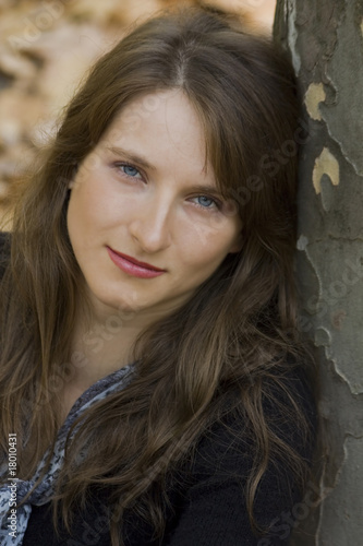 close-up portrait of young woman near the tree © Olga Lietunova