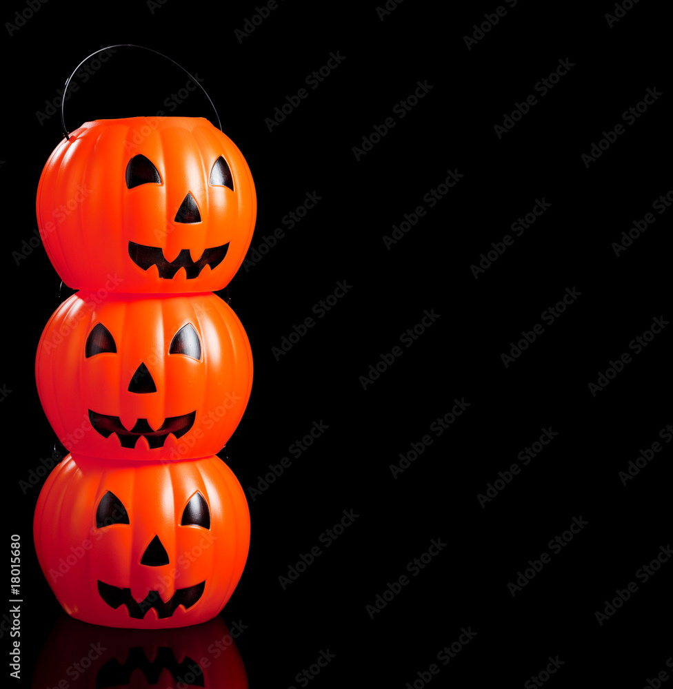 Fototapeta premium Stacked jack-o-lanterns on black