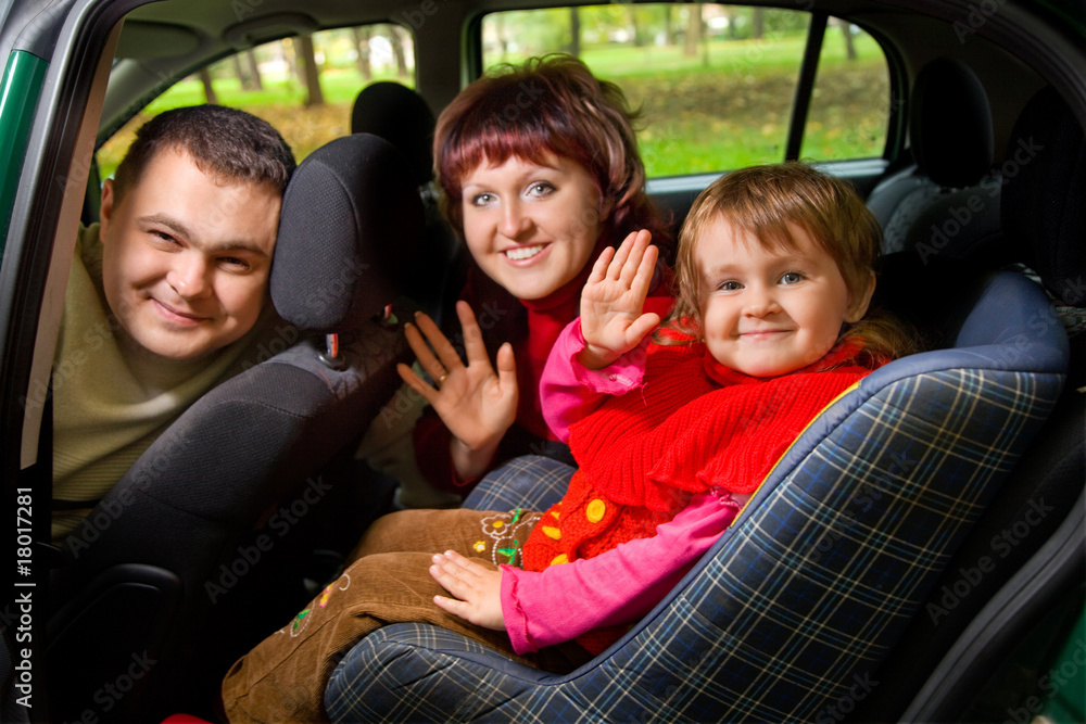 Married couple and  little girl  Greeting to wave hands in car i