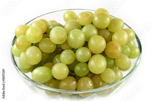 Green grapes in glass bowl isolated