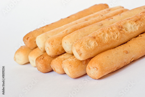 Sesame seed breadsticks on white