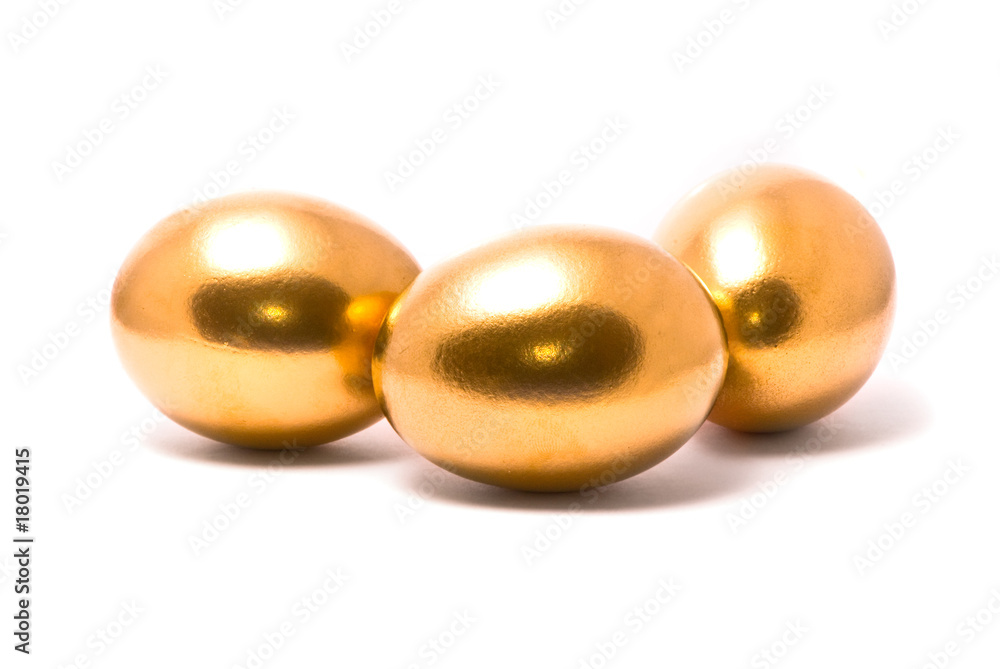 Three golden eggs on studio white background Three golden eggs on studio white background