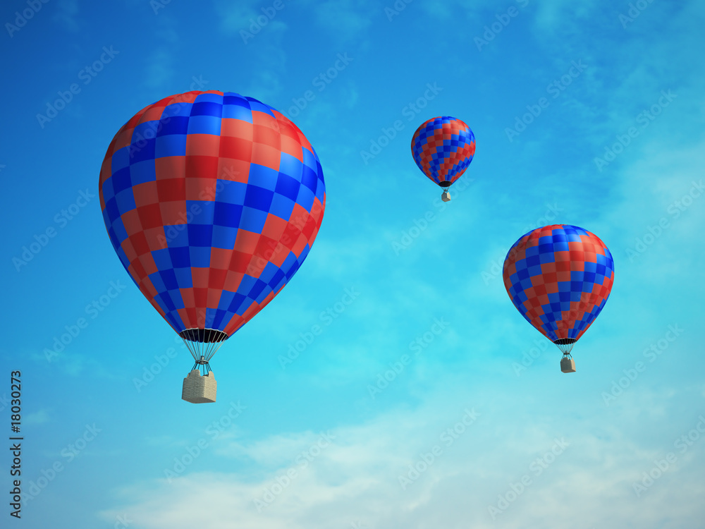 Fototapeta premium Three colorful hot-air balloons on a blue sky background