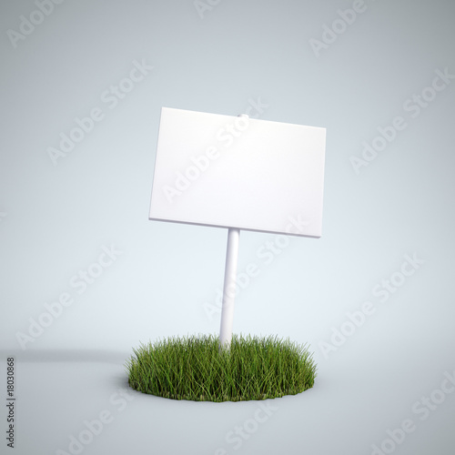 An empty sign on a patch of grass