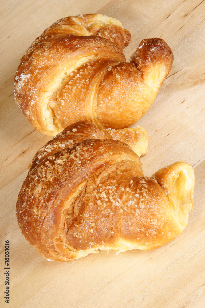 Two croissants over wooden background Two croissants over wooden background