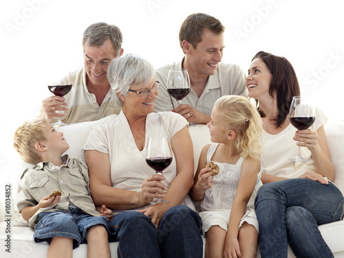 Family having a celebration with wine and eating biscuits