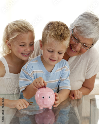 Quadro su tela Close-up of grandmother and children saving money