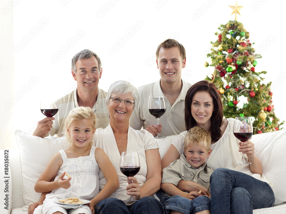 Obraz premium Family drinking wine and eating sweets in Christmas