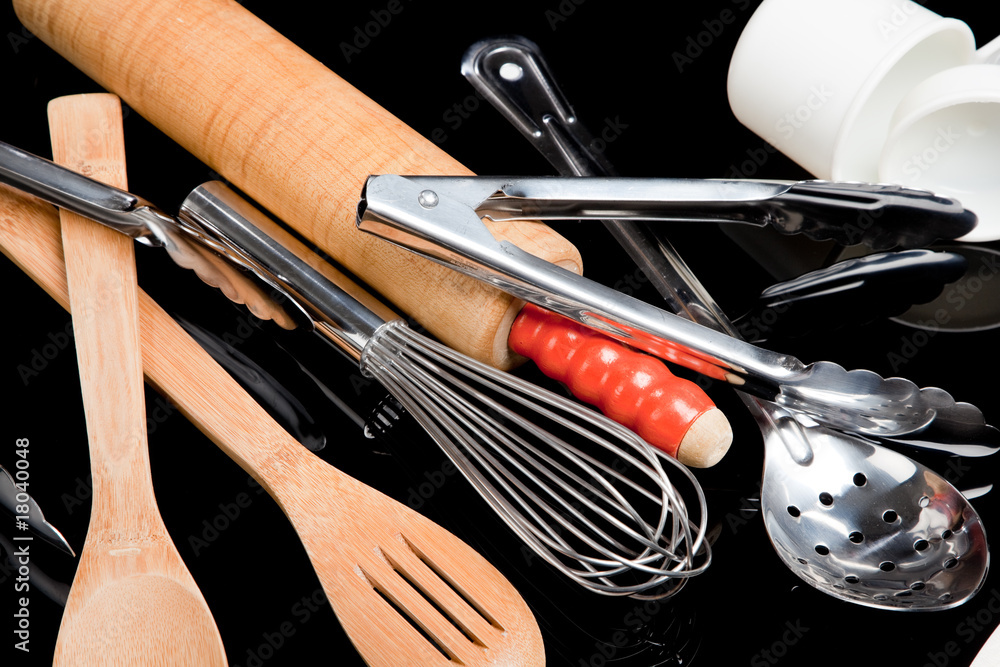 Fotografija Assorted cooking utensils on black