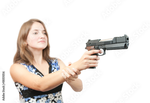 girl aiming a black gun. Focus on gun only