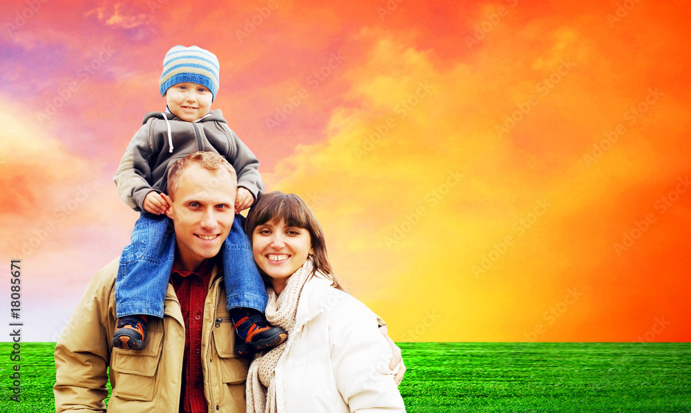 Happy family portrait outdoors smiling with a blue sky