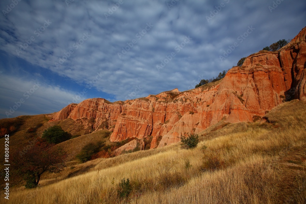 Red rocks in canyon and blue sky at sunrise