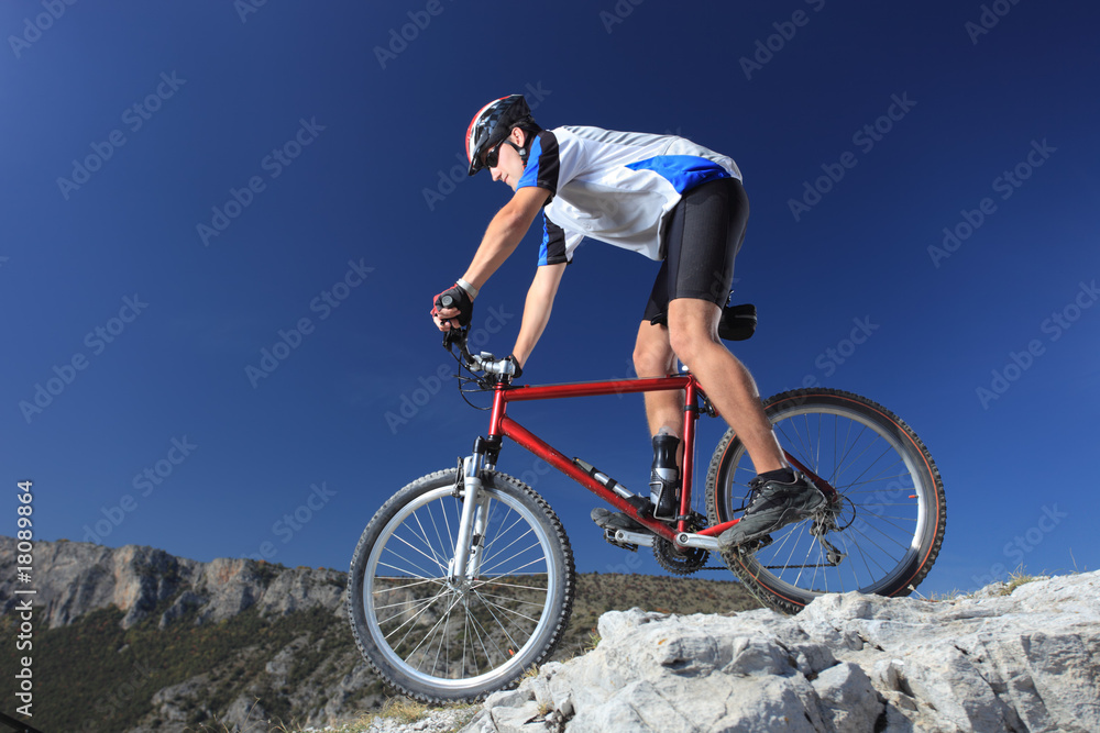 A man riding a mountain bike downhill style