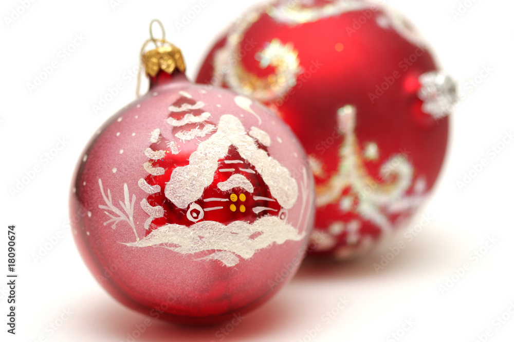 Two red christmas balls with drawing of house and snow isolated Two red christmas balls with drawing of house and snow isolated
