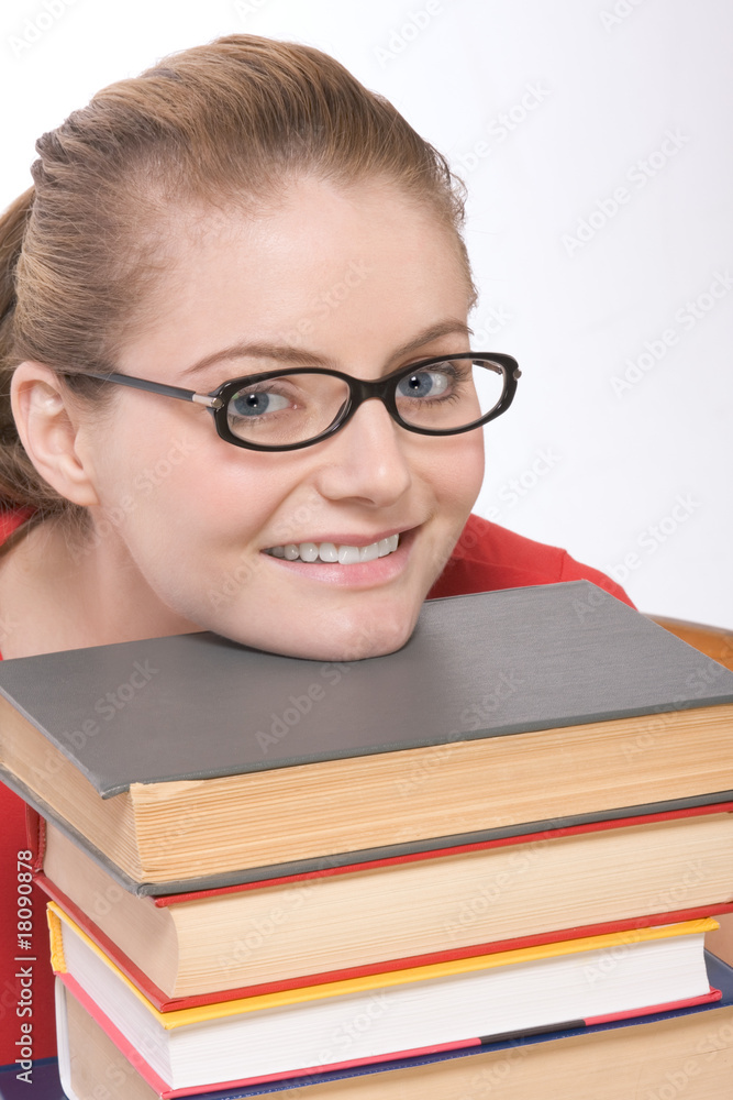 Caucasian student in eye glasses on pile of book Caucasian student in eye glasses on pile of book