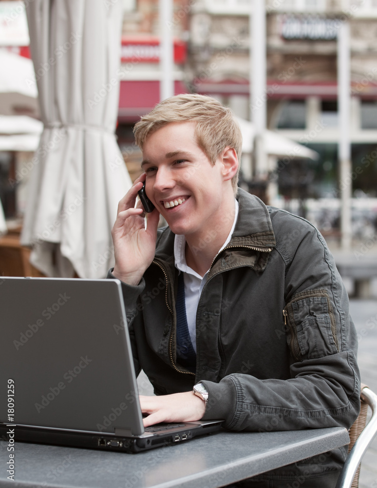 Young happy man with phone and laptop Young happy man with phone and laptop