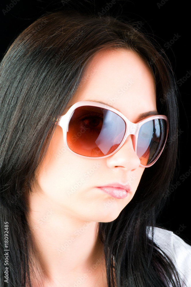 Young girl with sunglasses isolated on black Young girl with sunglasses isolated on black