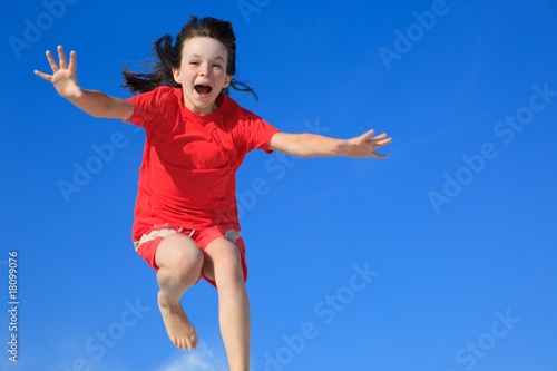 Happy girl jumping in air