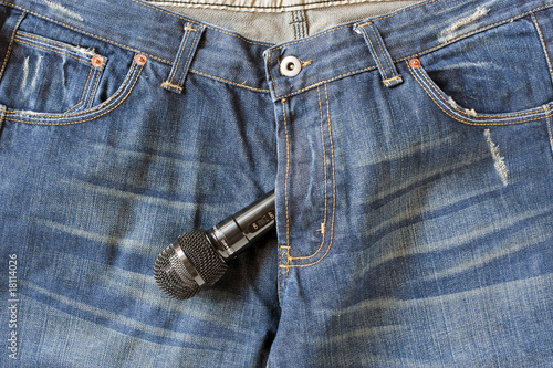Blue-jeans with a Microphone bulging out the zipper photo
