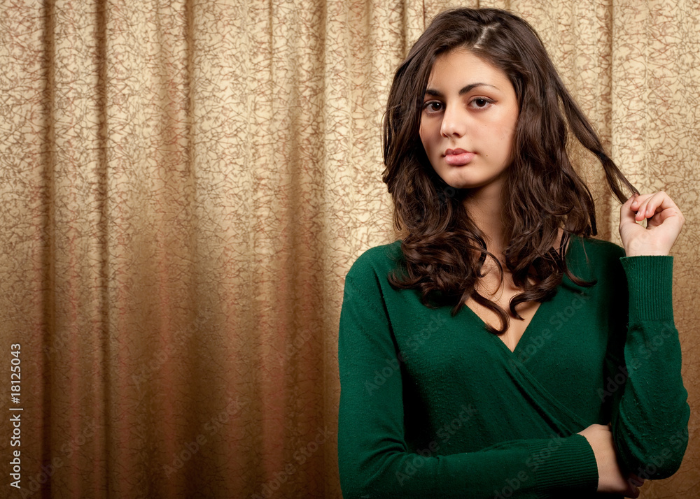 Fototapeta premium Beautiful young lady on golden curtain background