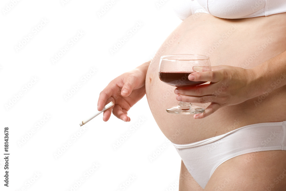 A close-up image of a pregnant woman holding a wine glass in one hand and a cigarette in the other, highlighting pregnancy health concerns.