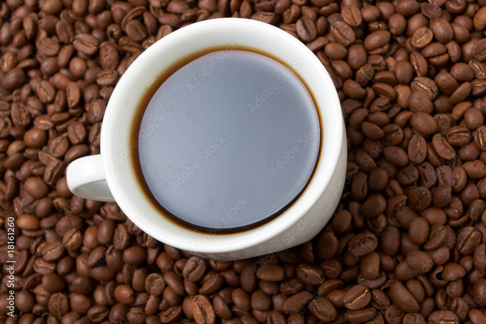 Fototapeta premium Cup with coffee, costing on coffee grain