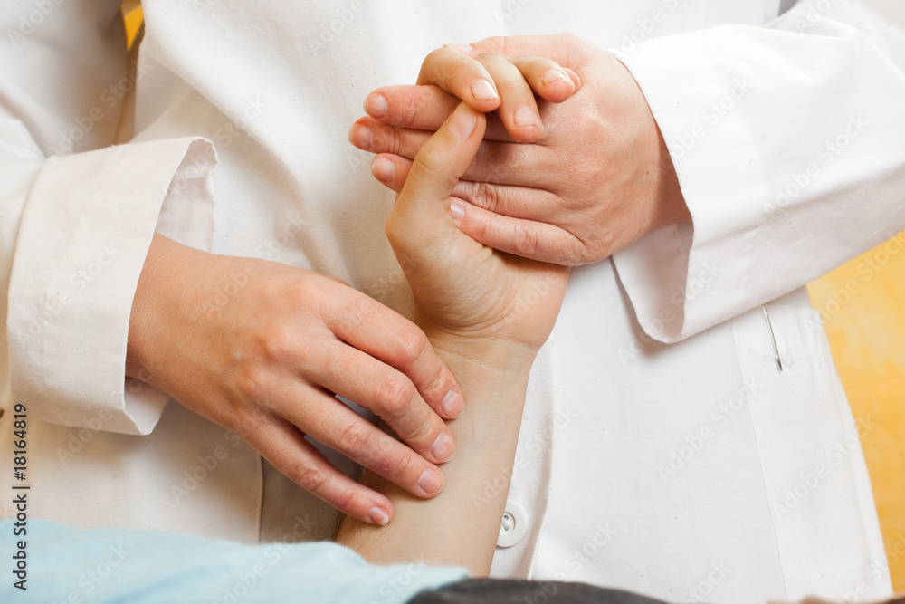 Chinese medical doctor checking a patients pulse