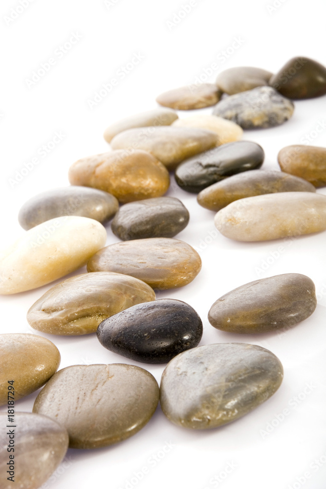 An array of smooth, multicolored stones arranged on a white background, showcasing natural beauty and variety. Ideal for themes of tranquility, nature, or decoration.