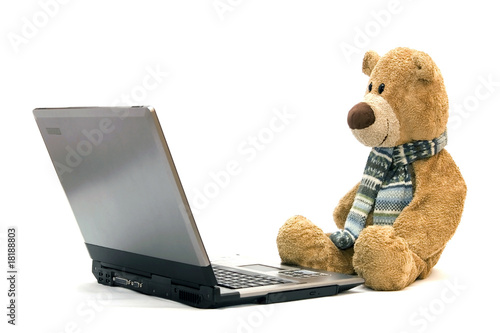 Teddy Bear and modern silver laptop