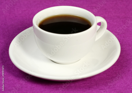 a cup of coffee on a pink background