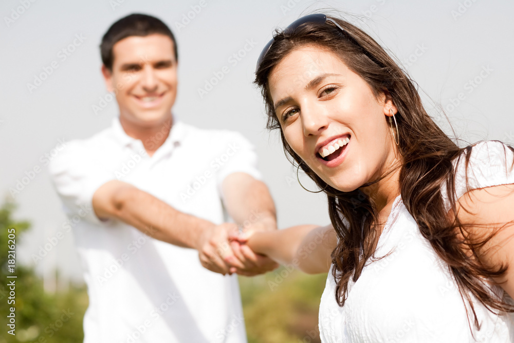 Happy young couple in playful mood focus on woman Happy young couple in playful mood focus on woman