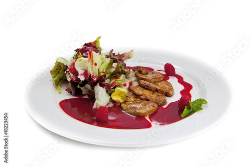 Plate with Foie gras, salad leaves, a raspberry and a syrup