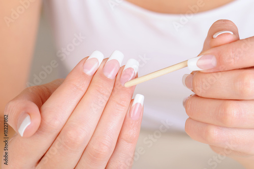 Female hand  with  stick for  cleaning cuticle