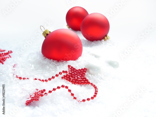 three red balls and stars in the snow