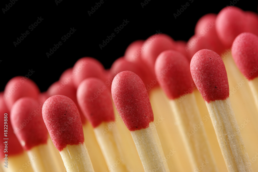 Line of red matchsticks on black background Line of red matchsticks on black background