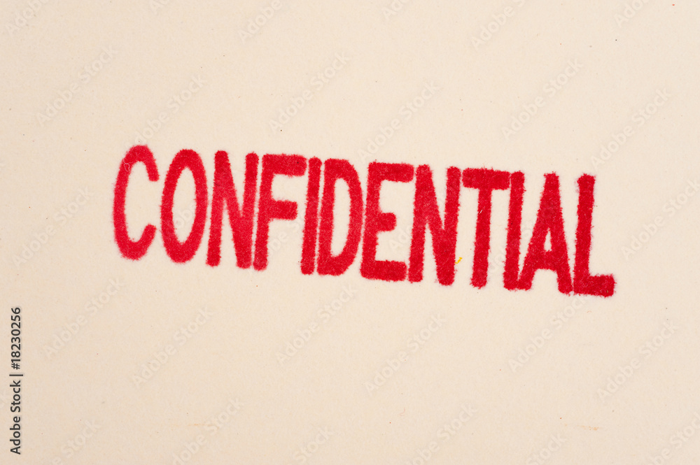 Red confidential stamp on a folder