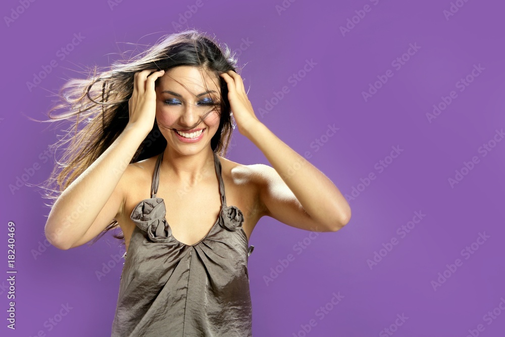 Brunette dancing at studio on purple background Brunette dancing at studio on purple background