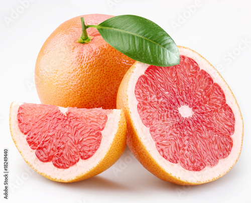 Grapefruits and segments with a leaf on a white background