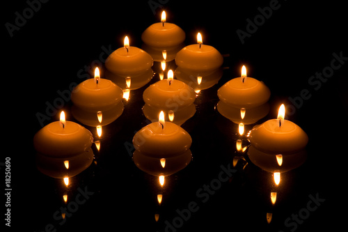 Wallpaper Mural Mirrored burning candles floating on water Torontodigital.ca